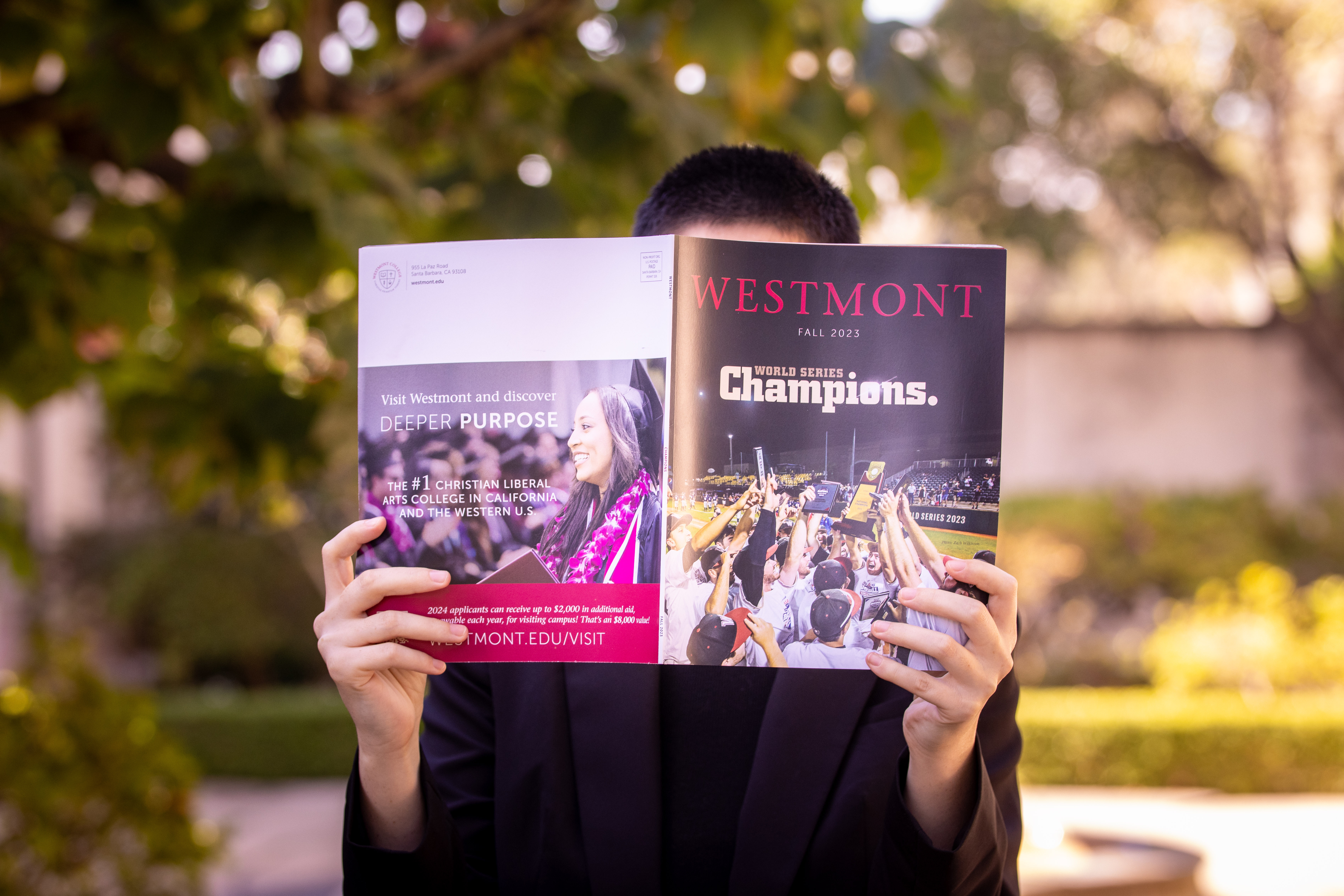 person holding up westmont magazine