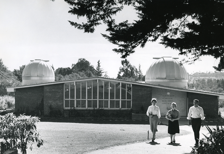 Three students walking in front of the Carroll Observatory.