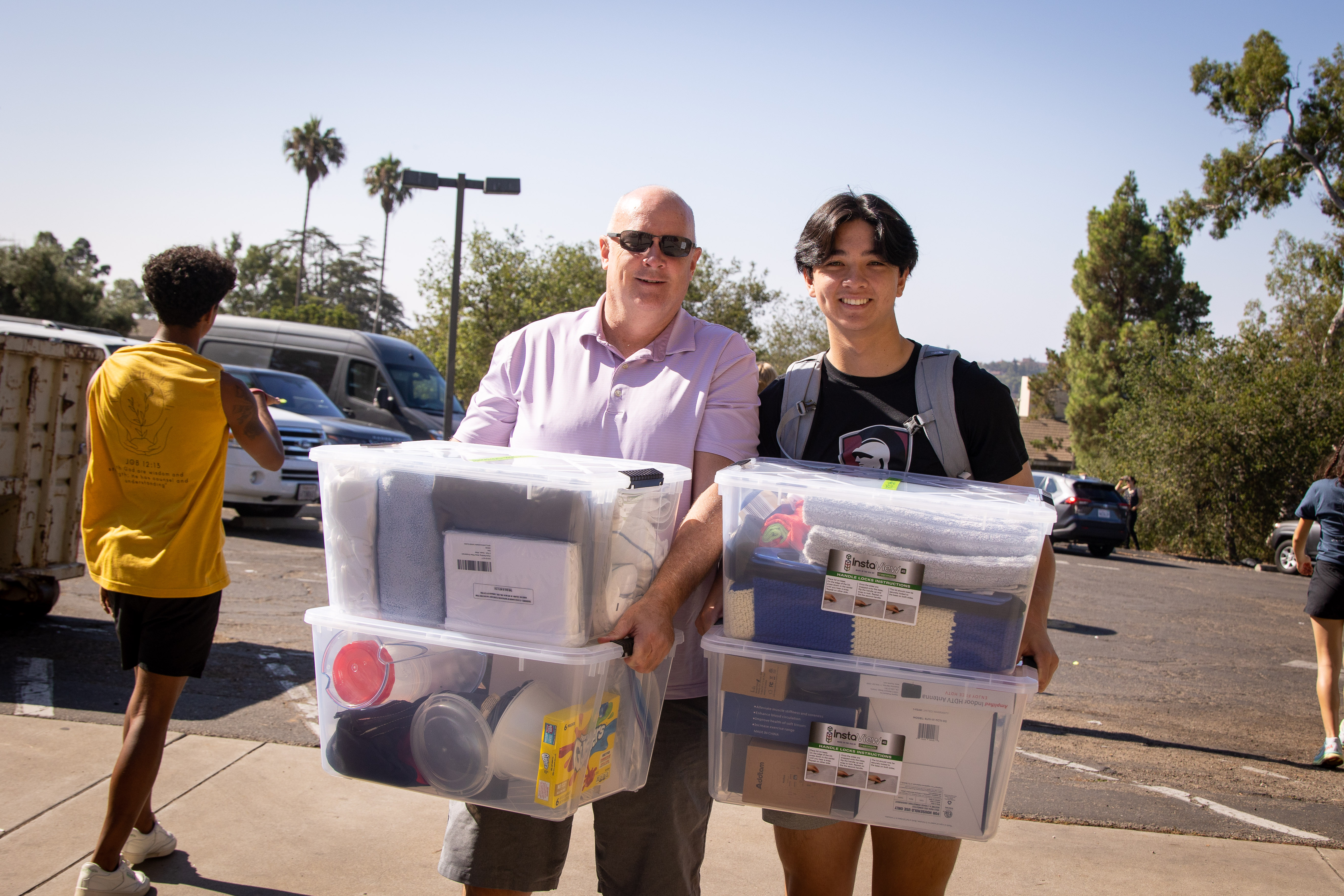 A father and son move items into a Westmont dorm.