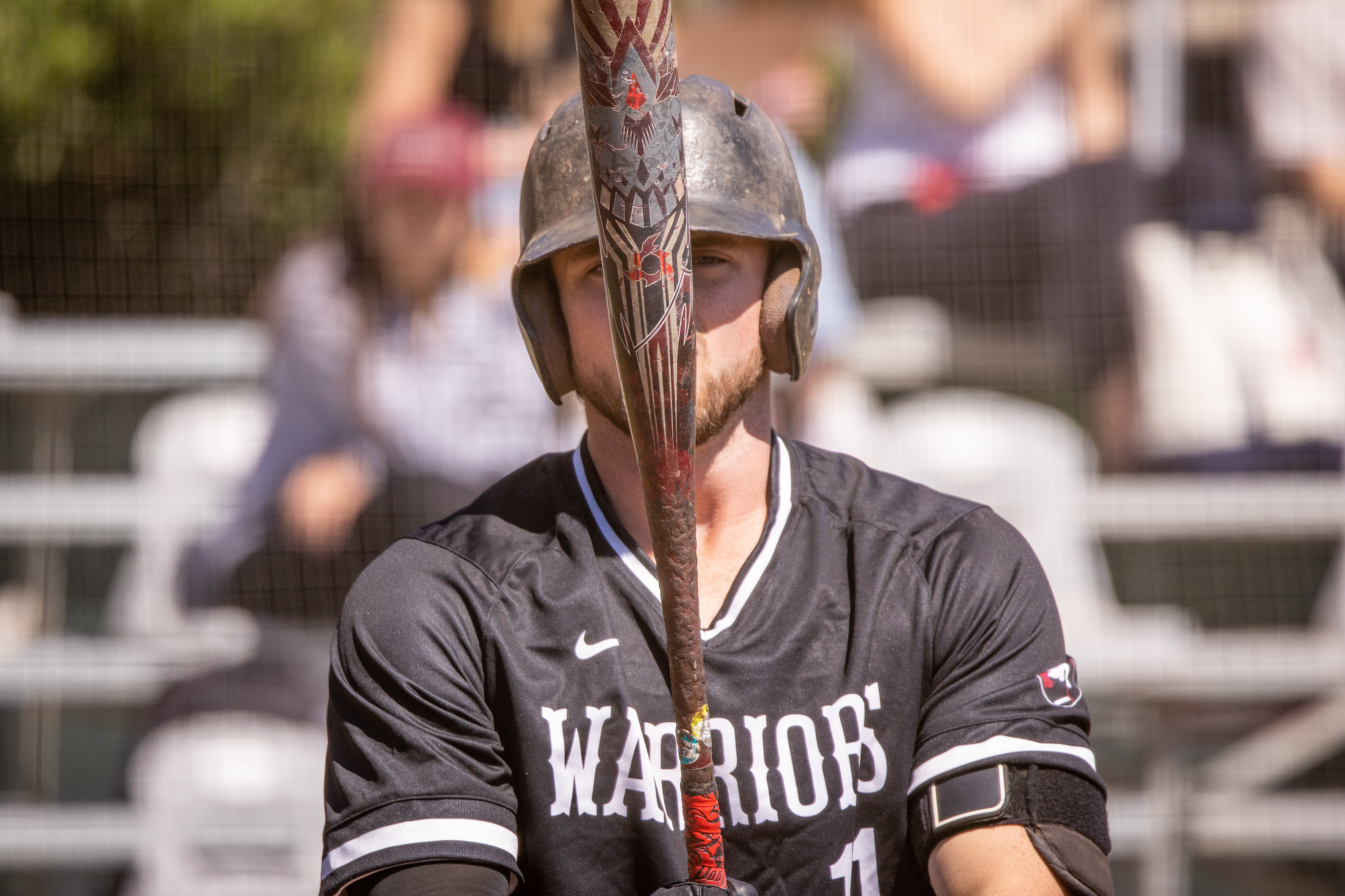 warrior baseball player holding bat