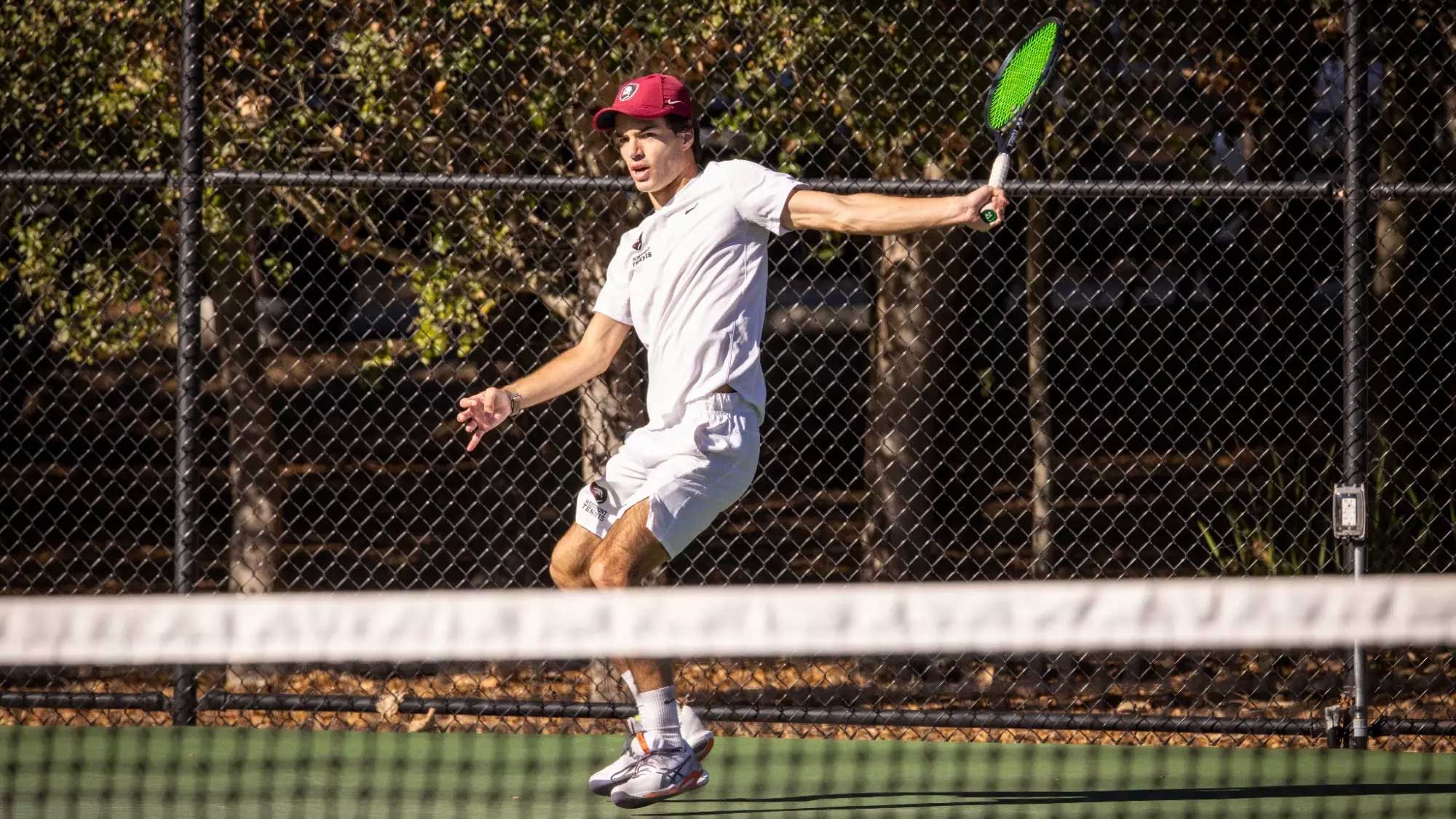 Men's Tennis player hits the ball 