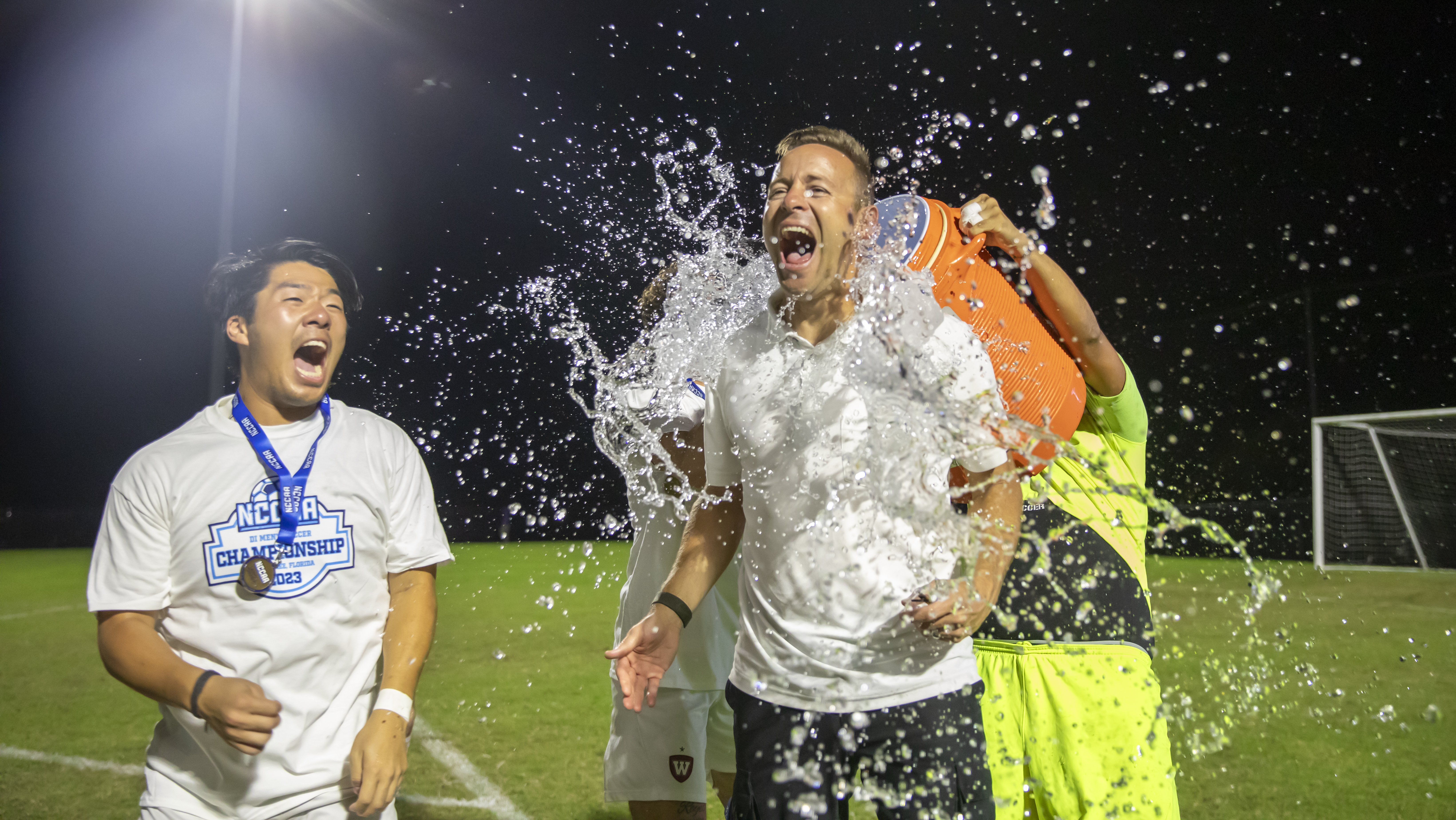 men's soccer water poured on player in celebration