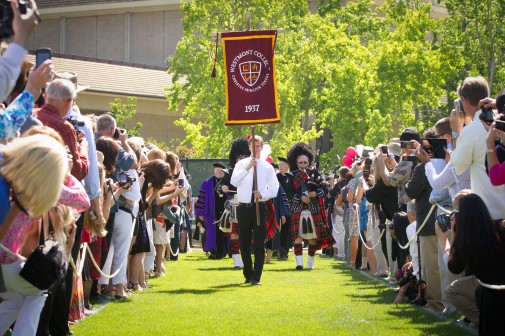 The Westmont banner, marking the college’s 75th anniversary, leads the procession