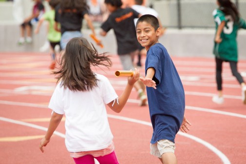 Danny Vera of McKinley Elementary School grabs the baton in an 8X50 co-ed race