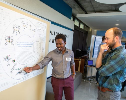 Chisondi Warioba explains his findings to Dr. Tim Van Haitsma.