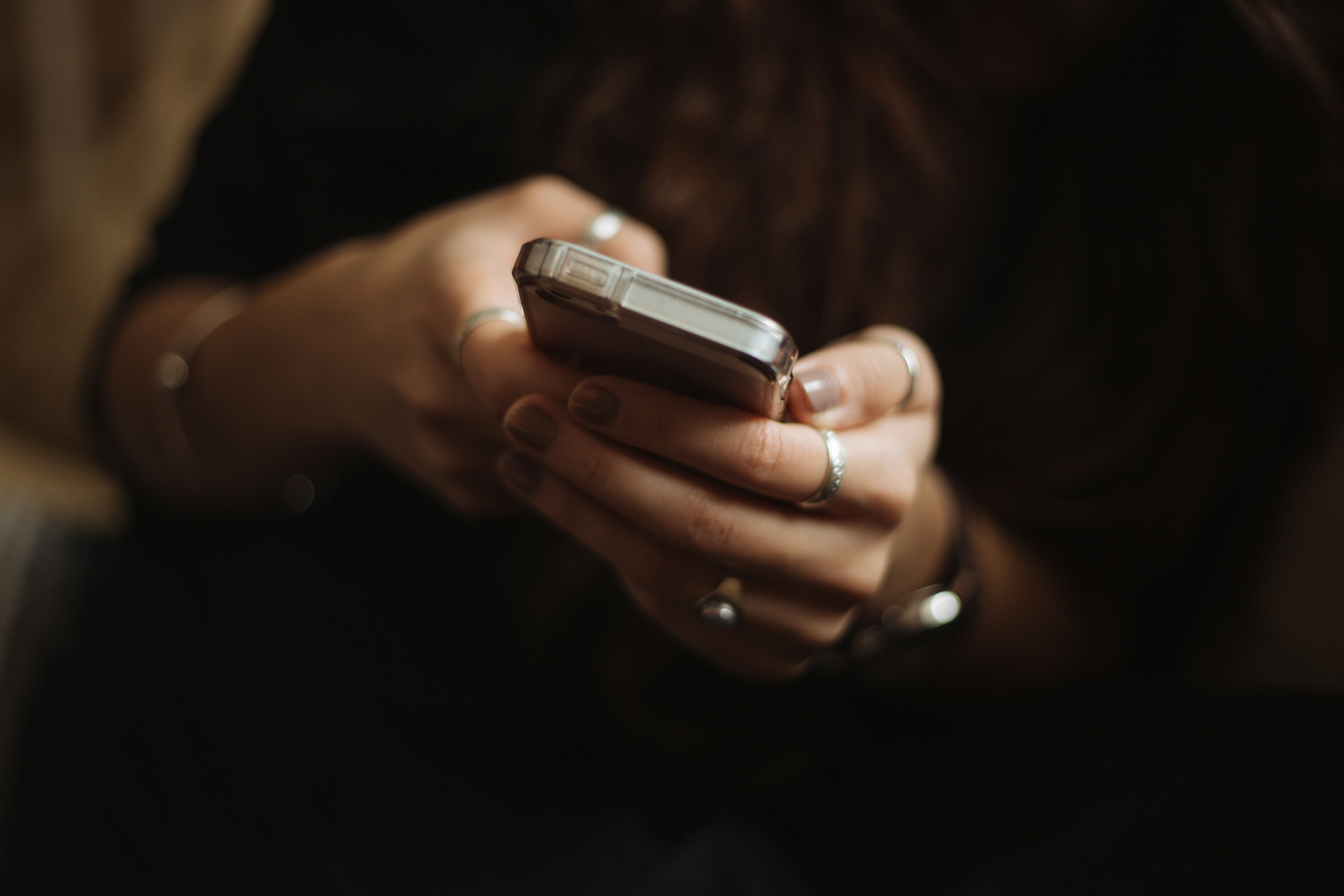 student texting on cell phone