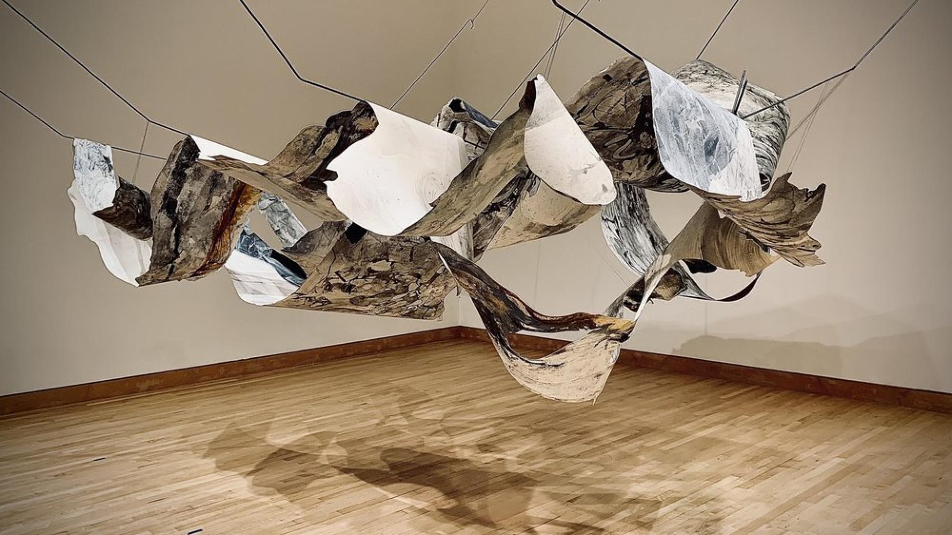 Suspended paper installation with watercolor details.