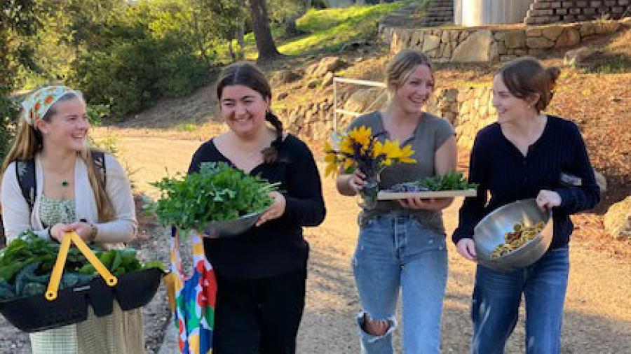 Students return from the garden with a harvest