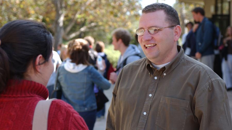 Stu Cleek talks to a student outside of Murchison Gym