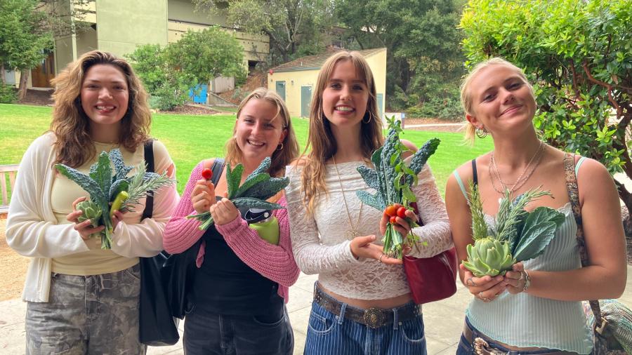 Students return from the garden with a harvest