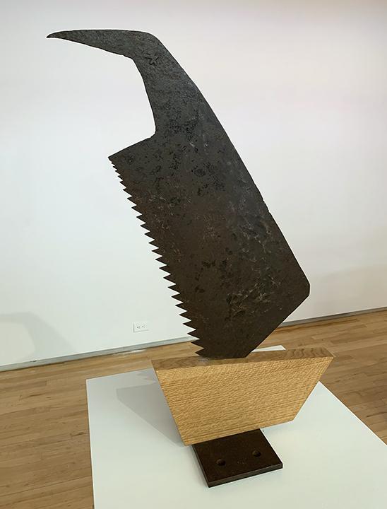 sculpture with saw and wood