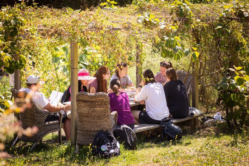 trailhead 2023 student sitting around a table in the garden