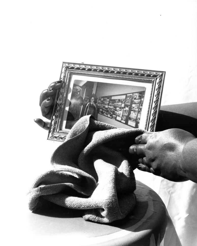 photo of hands holding a frame photo and towel