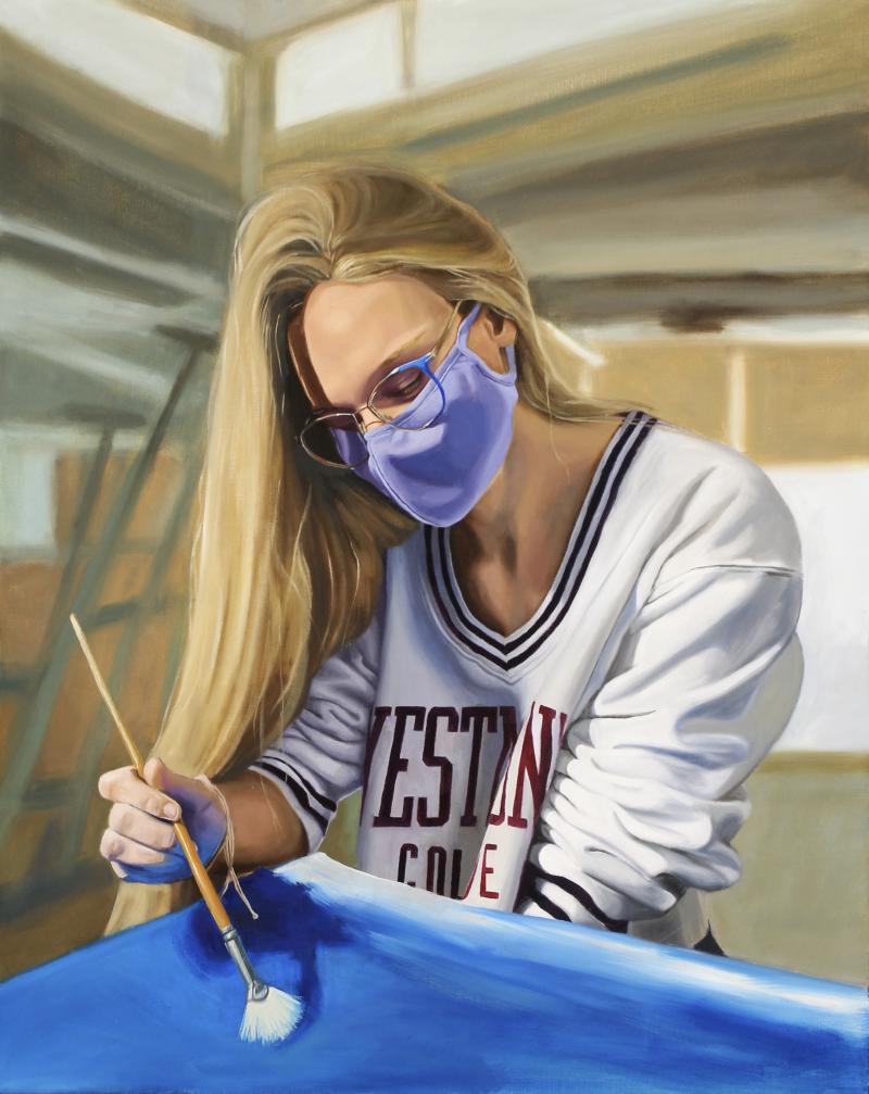 girl with mask painting in a studio