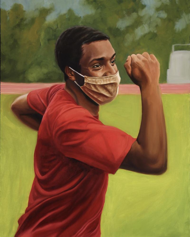 man in mask running on a track
