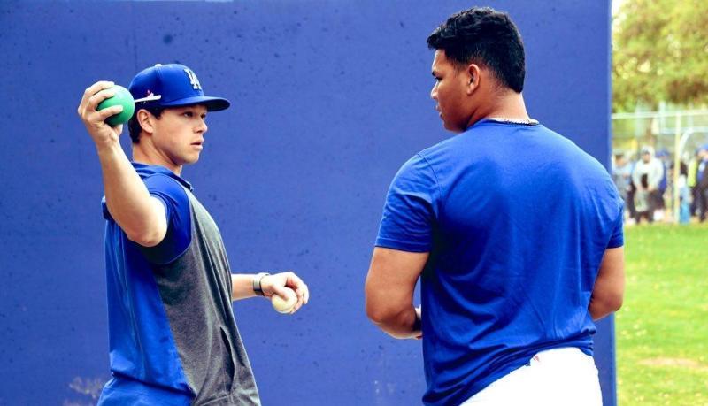 Hill demonstrates pitching technique, sporting Dodger blue.