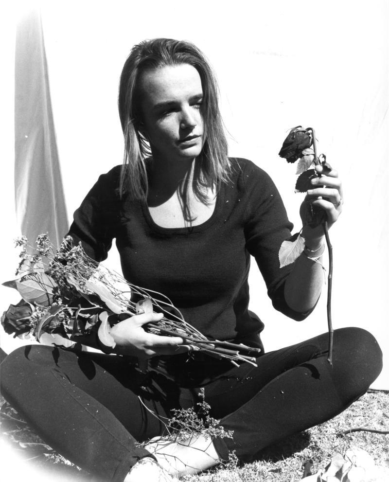 photo with figure holding rose bouquet