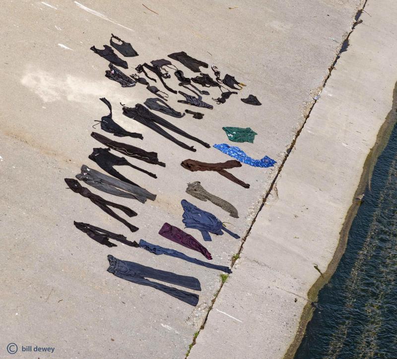 wet clothes laid out on concrete