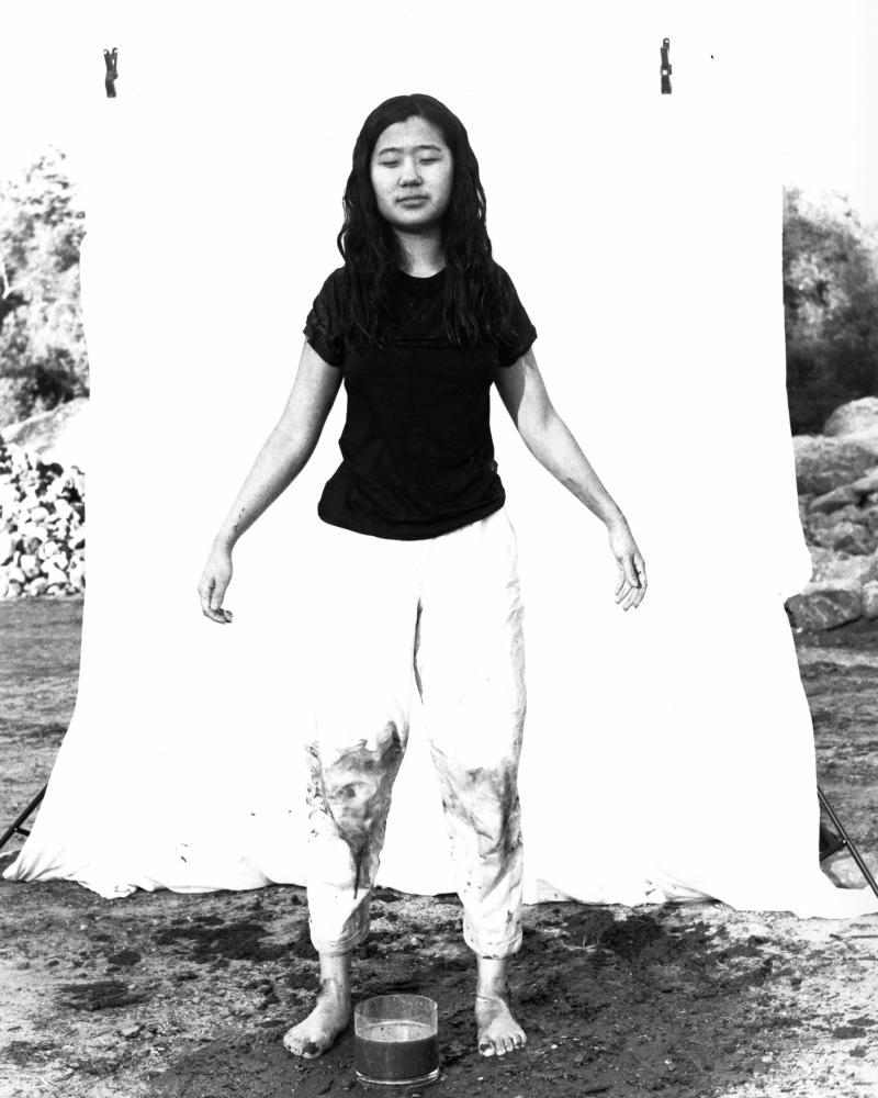 photo of figure standing with mud on pants