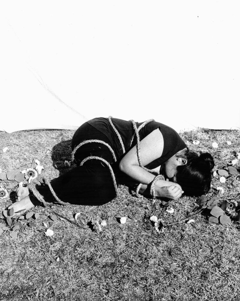 photo of figure wrapped in rope