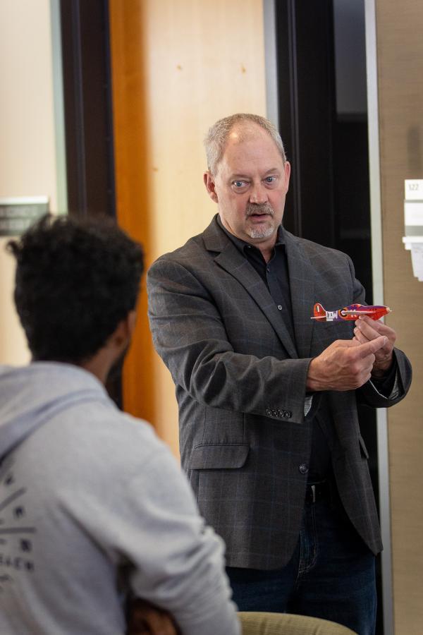 Dan Jensen talks with a student