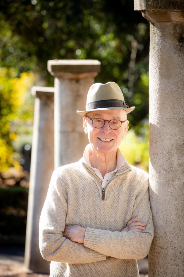 Bob Gundry standing near columns on campus