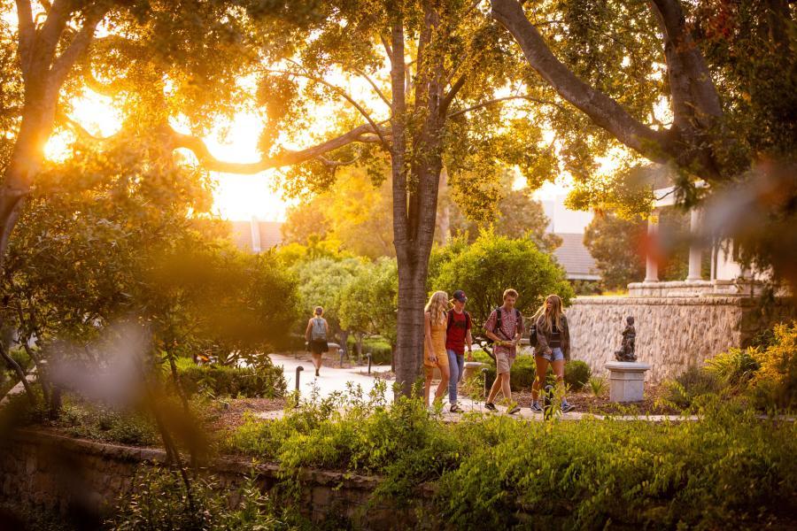 Students walking through gardens.