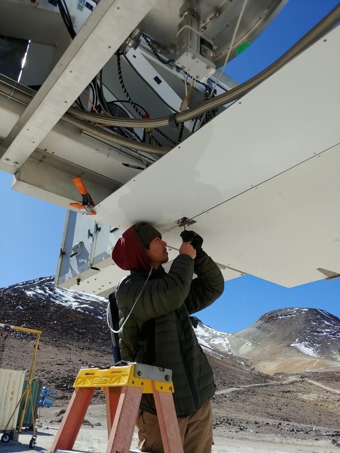 Student Michael Lew works on a telescope at 17,000 feet