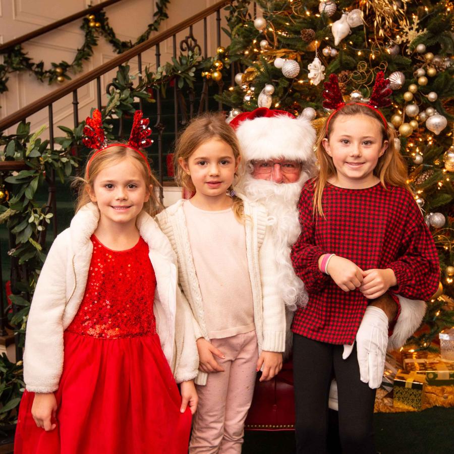 Santa Claus poses for pictures with children 