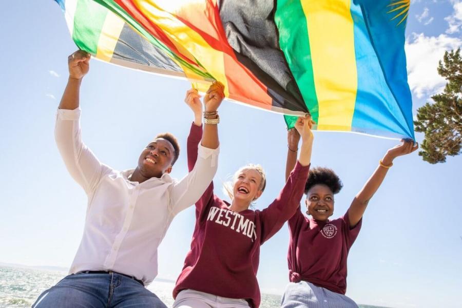 international students holding up flag